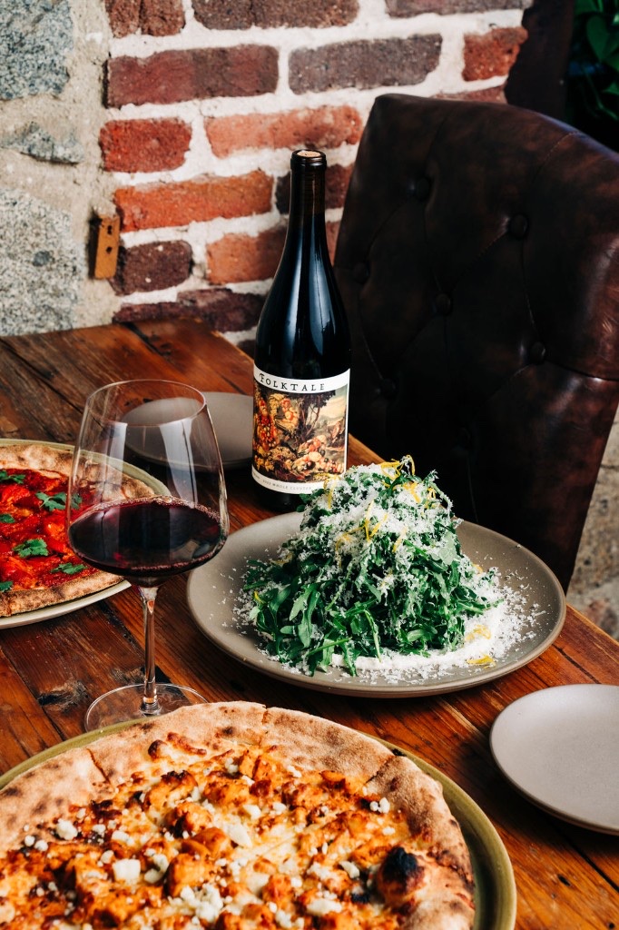 Arugula salad with parmesan and wood-fired pizza at Stone House catering