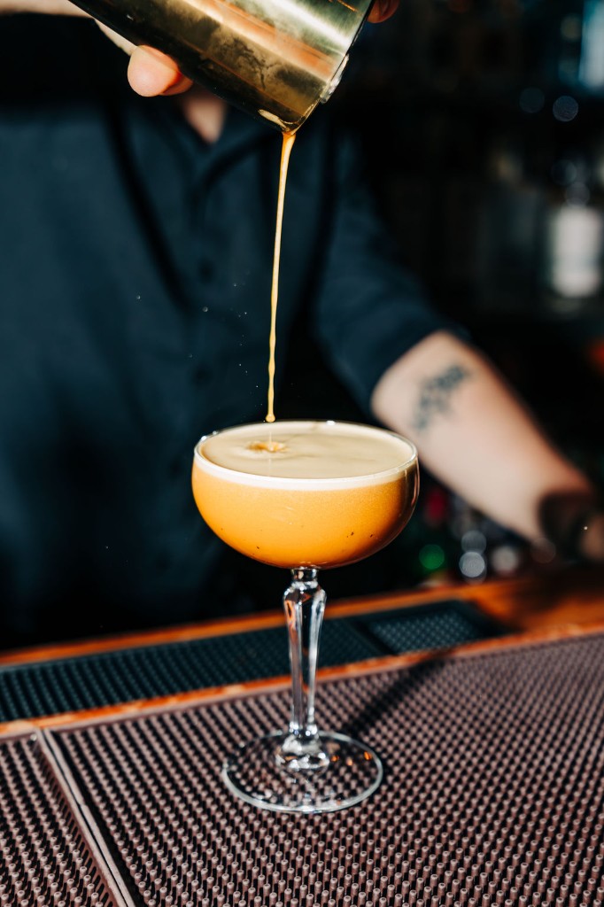 Bartender pouring espresso martini at Stone House catering bar