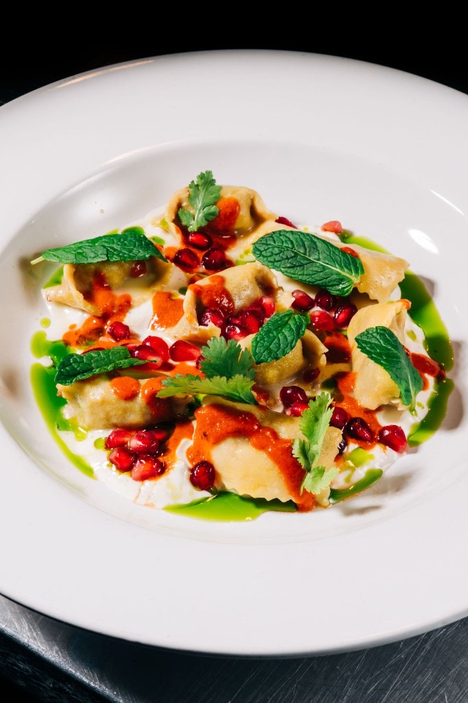 Handmade agnolotti with yogurt sauce, chili oil, and pomegranate at Stone House