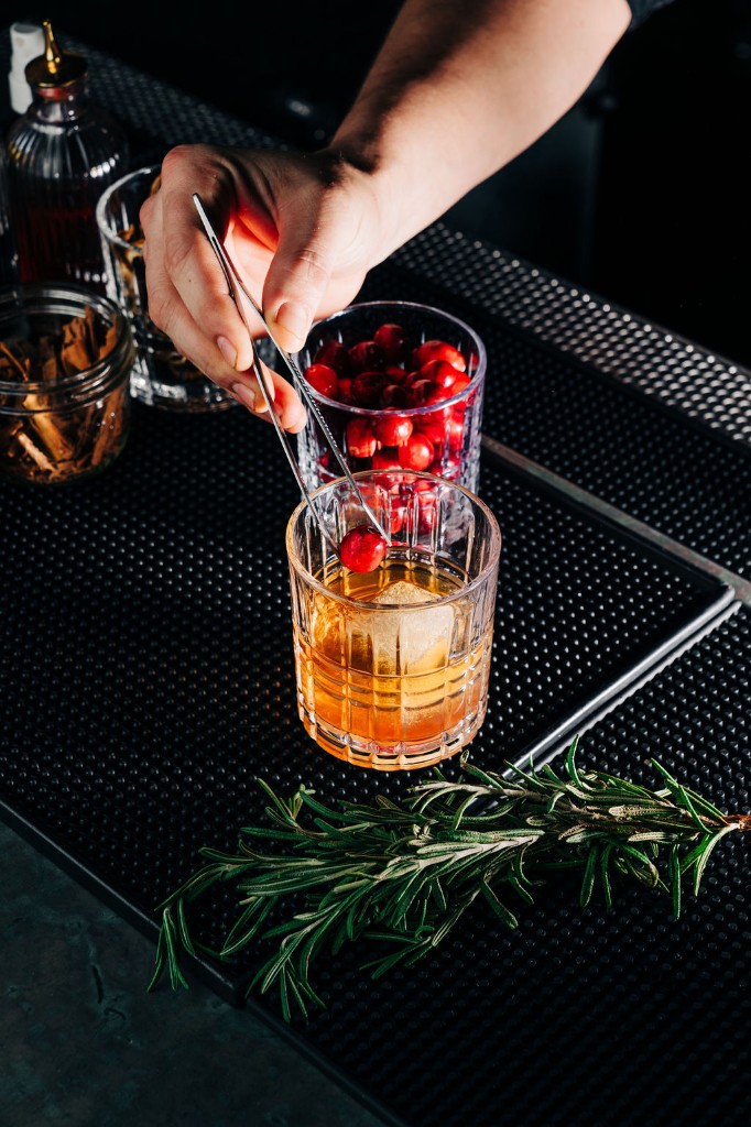 Maple old fashioned cocktail with rosemary garnish at Stone House bar