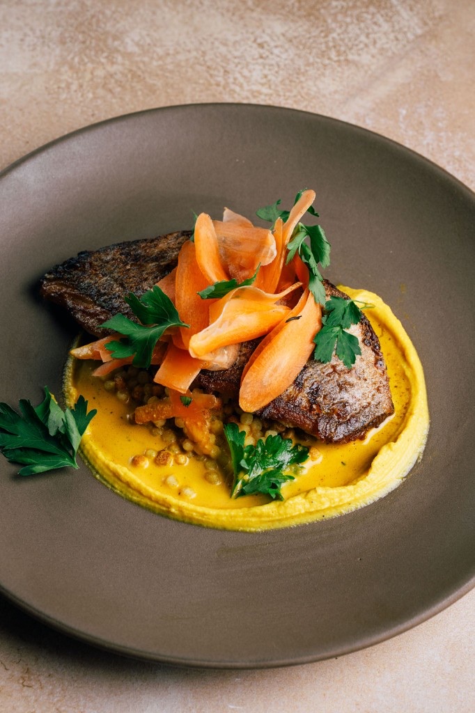 Pan-seared fish with saffron purée and shaved carrot at Stone House catering