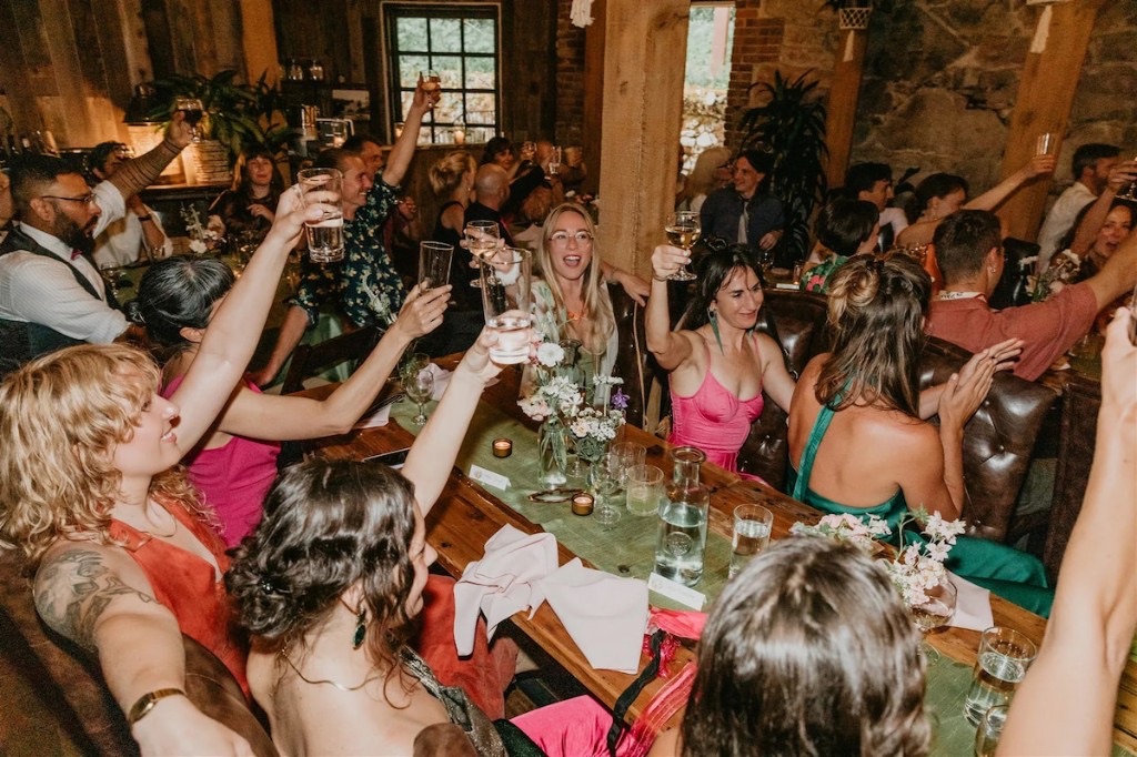 Wedding reception toast with guests in The Great Hall at Stone House Nevada City