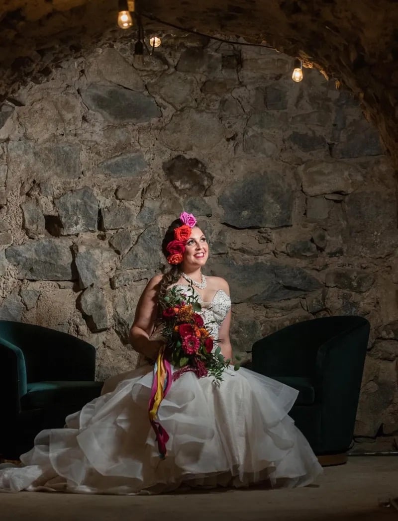 Wedding reception in The Cavern at Stone House Nevada City — candlelit dinner under historic stone arches