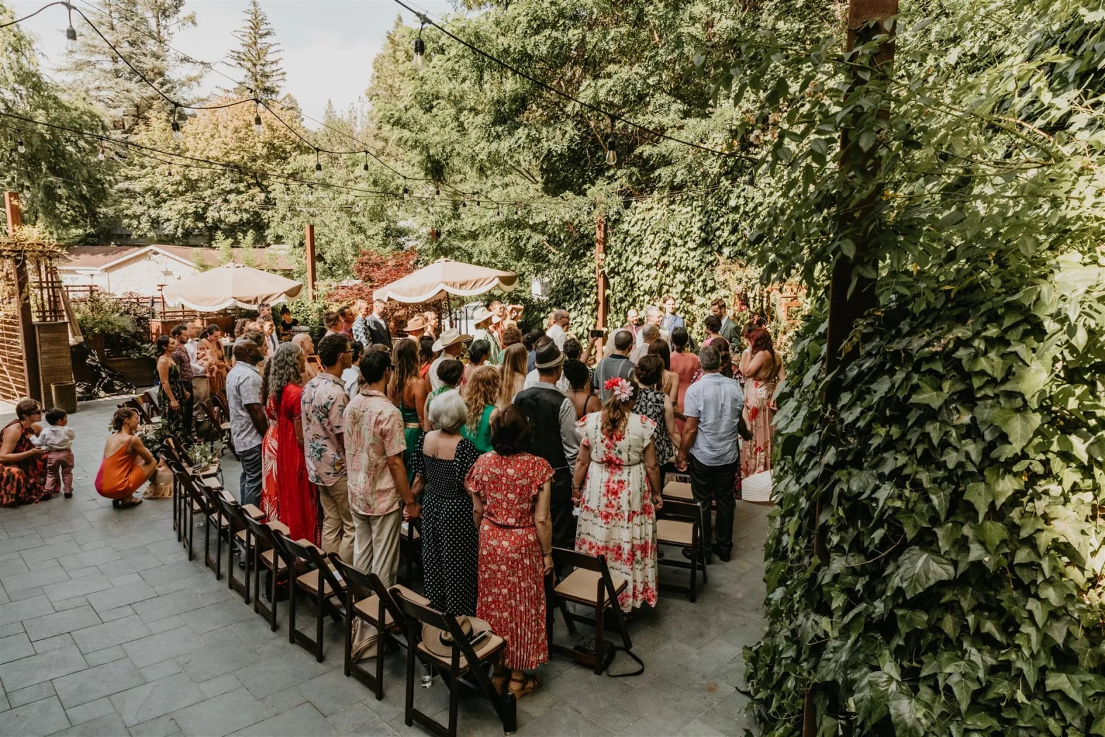 Wedding couple portrait in The Courtyard at Stone House Nevada City — original stone walls and golden hour light