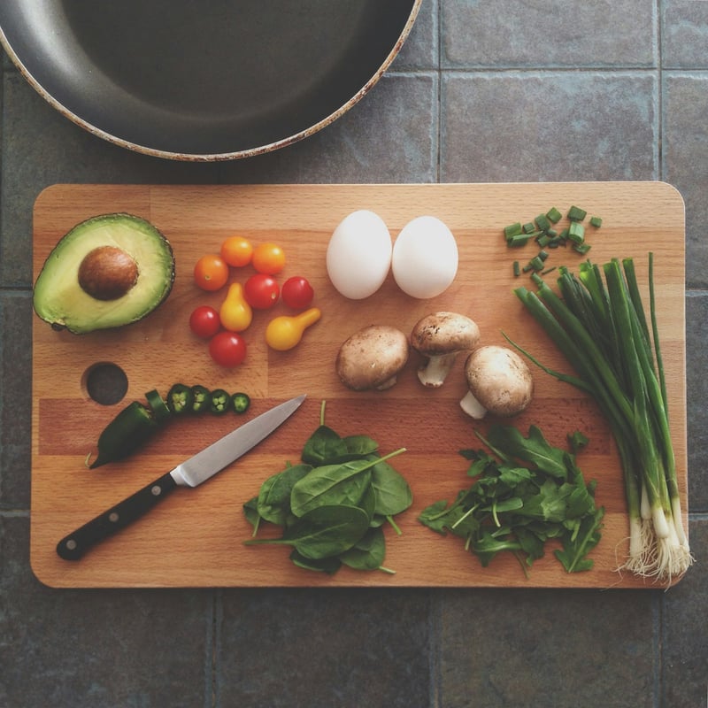 Fresh seasonal vegetables and herbs on a cutting board — illustrative photo for farms post