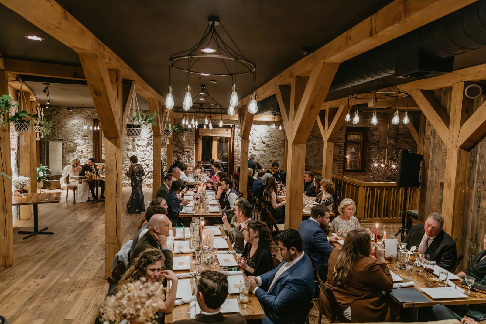 Wedding reception overview in The Great Hall at Stone House Nevada City — original stonework and arched ceiling