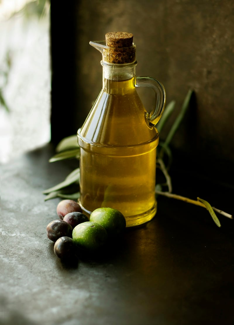 Premium olive oil being poured — the foundation of seed-oil-free cooking