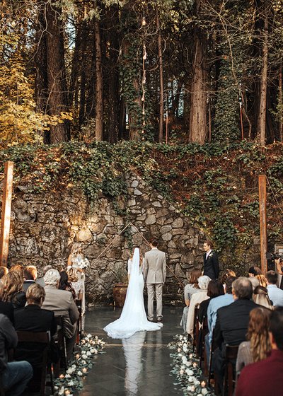 Real wedding celebration at Stone House Nevada City — couple's first dance in the candlelit reception hall surrounded by guests