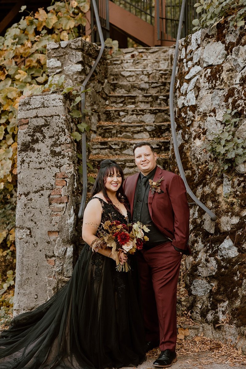 Real wedding celebration at Stone House Nevada City — couple's first dance in the candlelit reception hall surrounded by guests