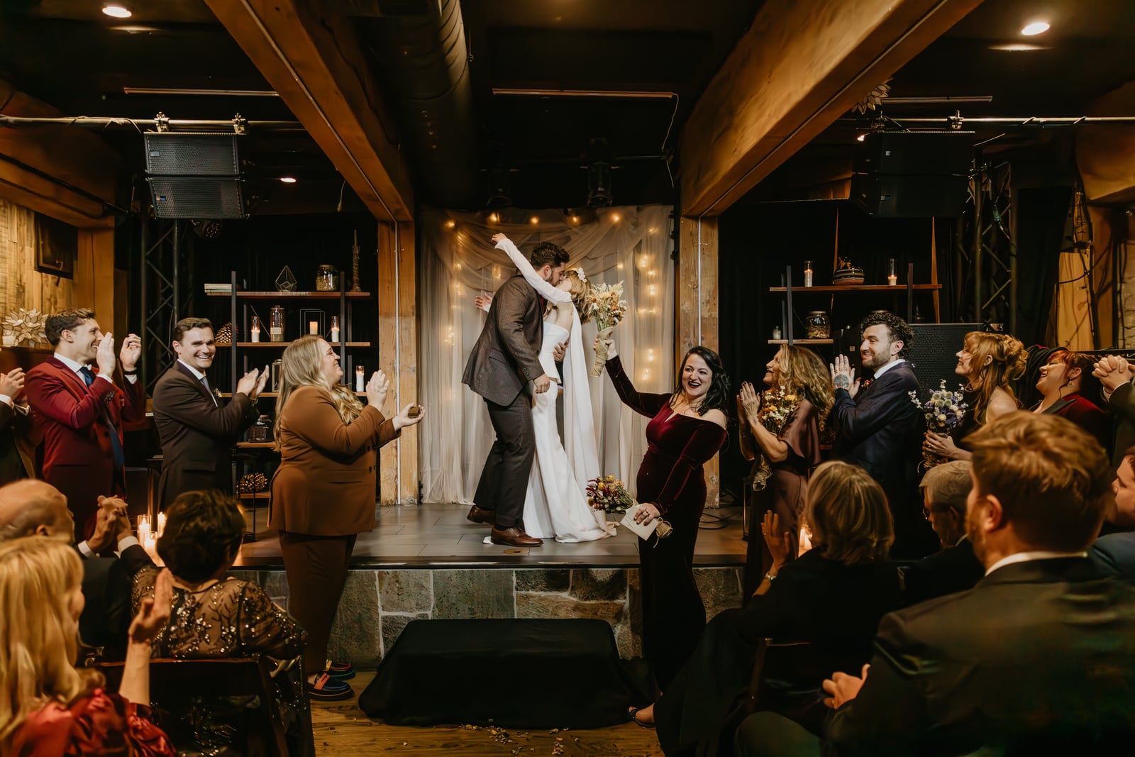 Wedding reception celebration in The Showroom at Stone House Nevada City — first-floor flexible venue with exposed beams and warm lighting