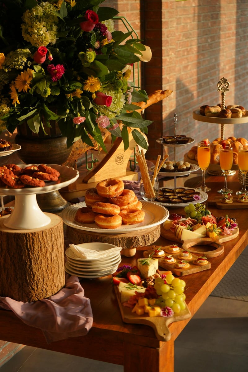 Elegant brunch buffet spread with pastries, mimosas, and fresh flowers