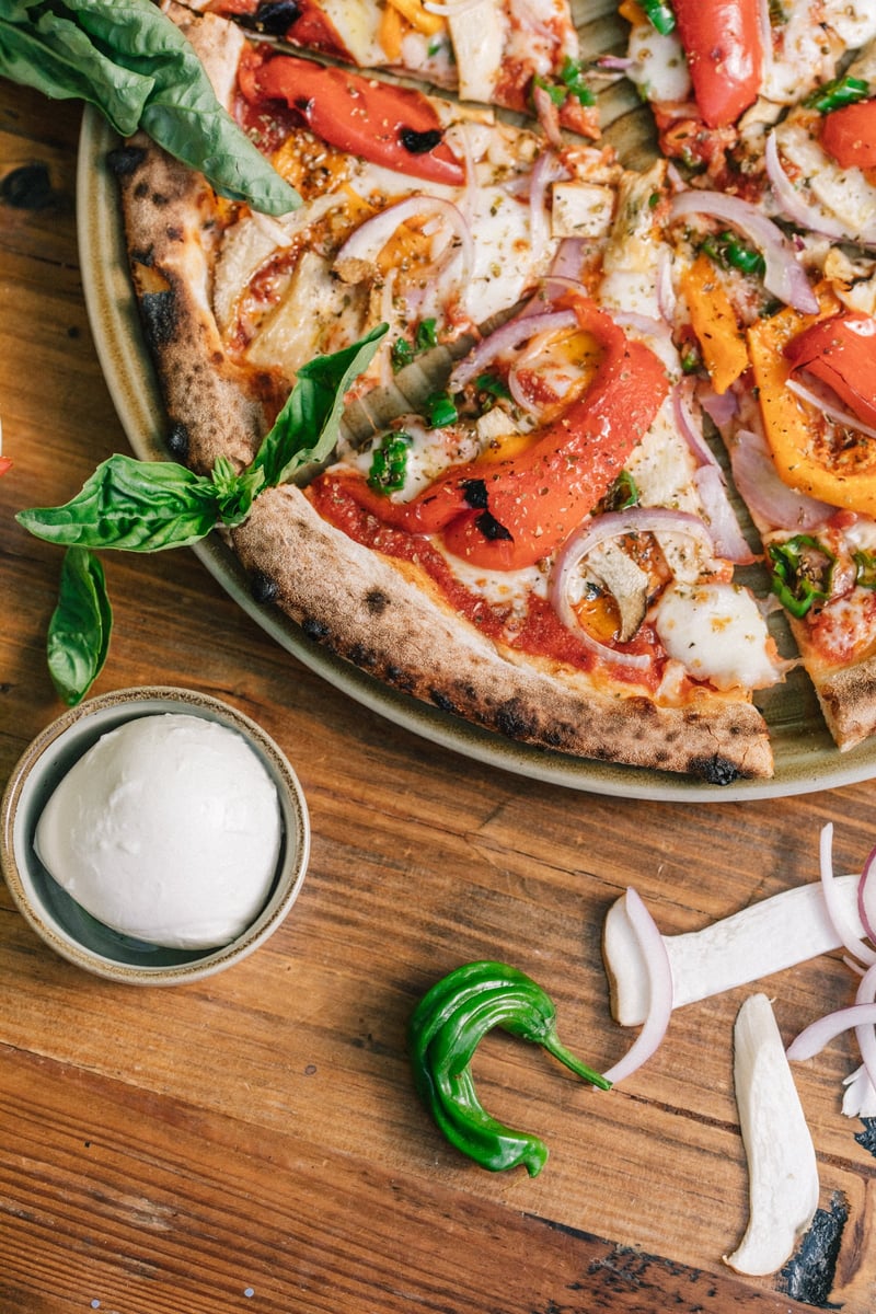 Wood-fired vegetable pizza on a Stone House Nevada City catering table